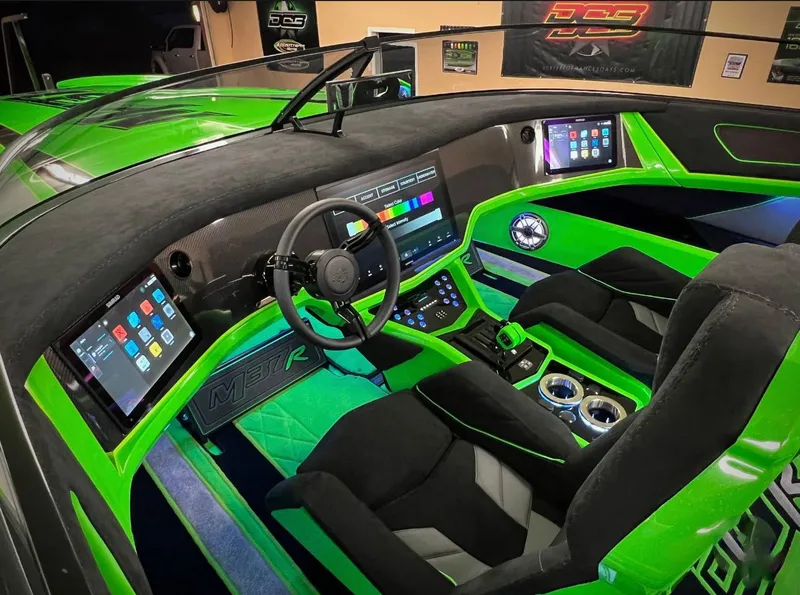 Slide: The Image of 2023 Daves Custom Boats M37R interior with vibrant green accents and advanced digital displays. - 8