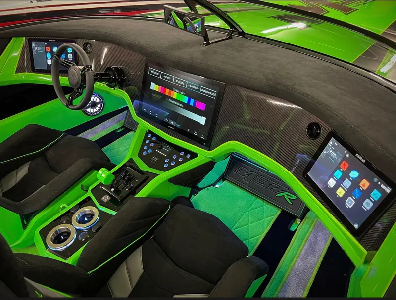 Slide: The Image of 2023 Daves Custom Boats M37R interior with vibrant green accents and advanced digital displays. - 9
