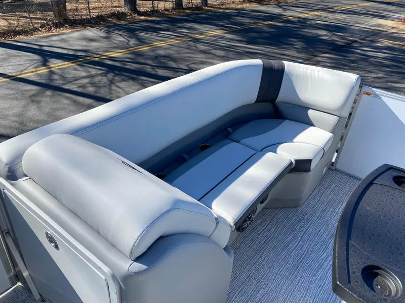 Slide: The Image of 2025 SunCatcher Select 322RC boat interior with gray seating and cup holders. - 15