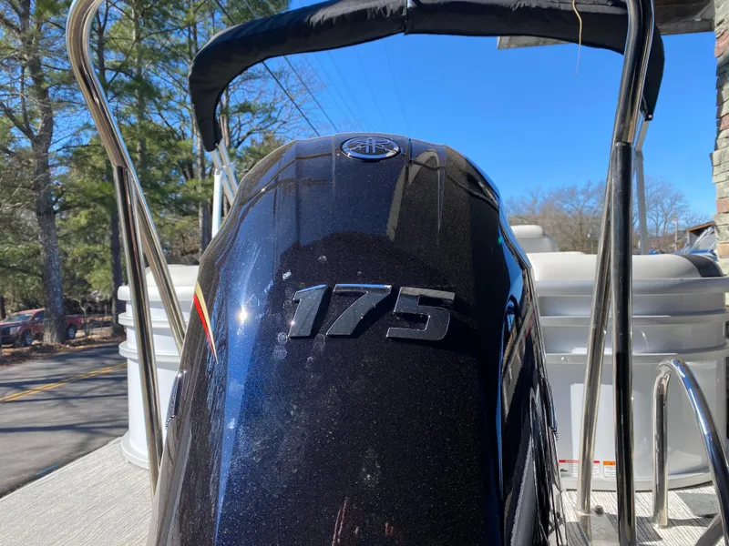 Slide: The Image of SunCatcher Select 322RC 2025 boat with 175 HP engine, outdoor setting. - 17