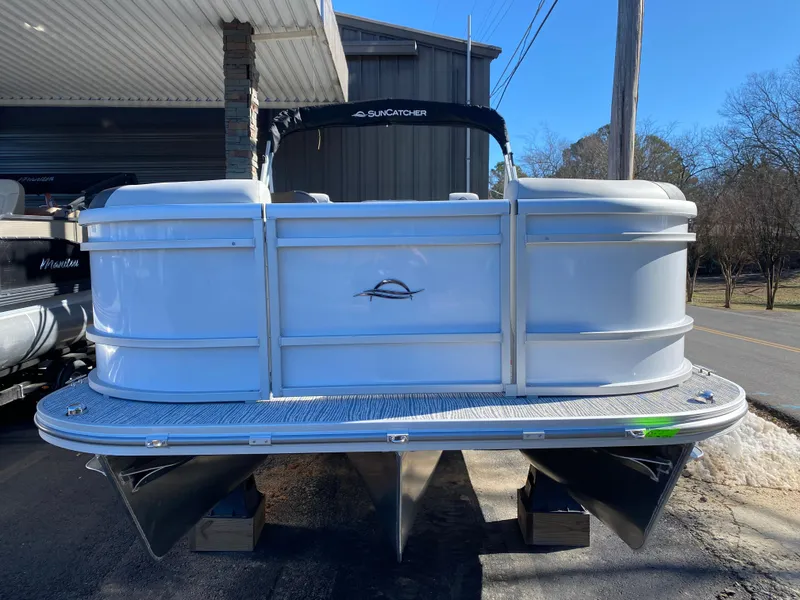 Slide: The Image of 2025 SunCatcher Select 322RC pontoon boat displayed outdoors. - 2