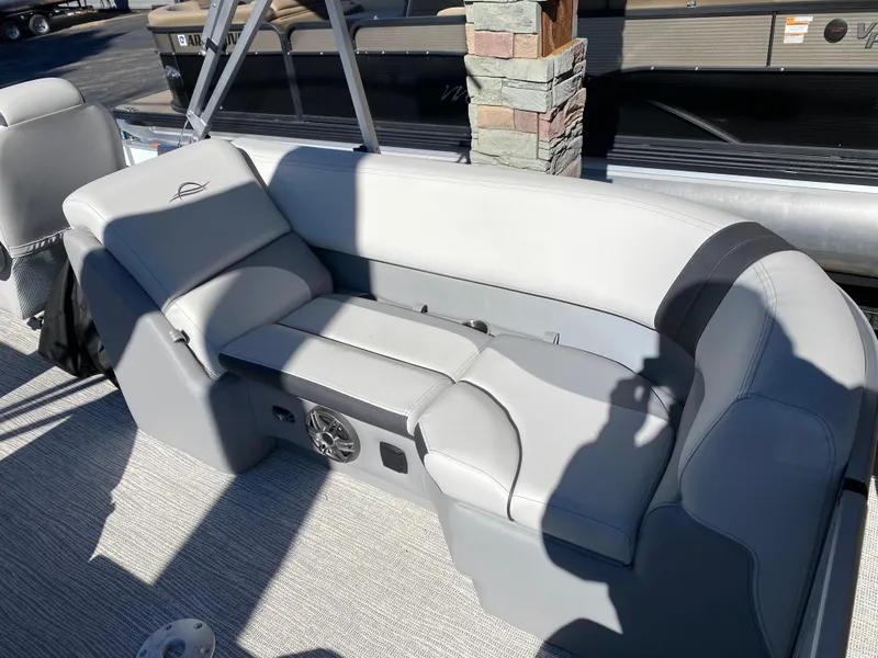 Slide: The Image of 2025 SunCatcher Select 322RC boat interior with gray seating and speaker system. - 5