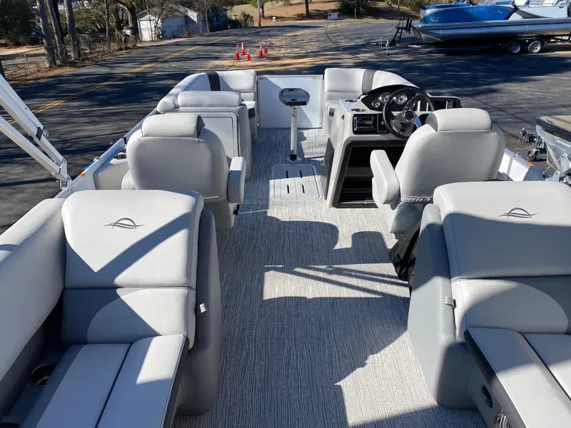 Slide: The Image of 2025 SunCatcher Select 322RC pontoon boat interior with gray seating and steering console. - 7