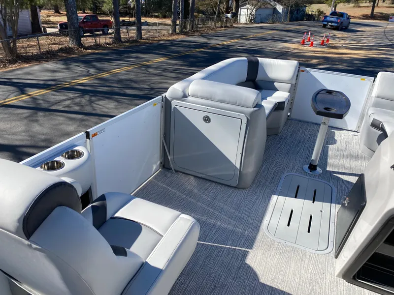 Slide: The Image of Interior of 2025 SunCatcher Select 322RC pontoon boat with plush seating and modern design. - 9