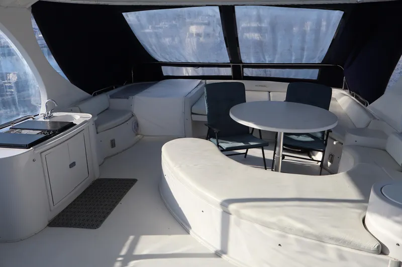 Slide: The Image of 2006 Bluewater Yachts 5200 interior with seating area and kitchenette. - 11