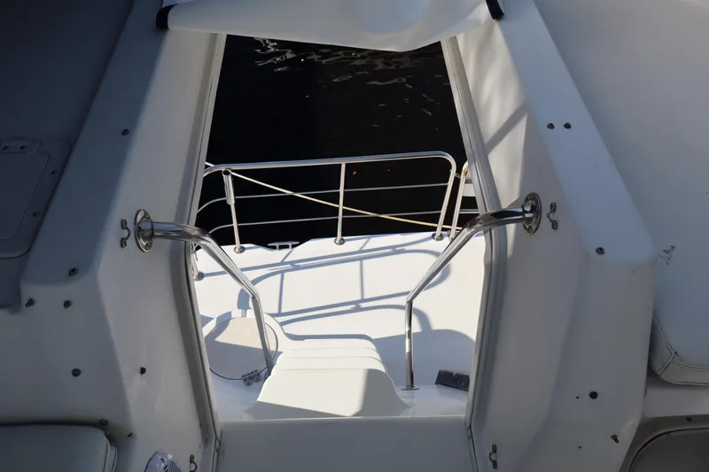 Slide: The Image of Entrance to 2006 Bluewater Yachts 5200, featuring stainless steel railings and white deck. - 14