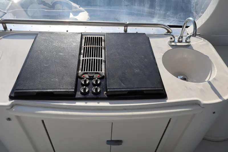 Slide: The Image of Outdoor kitchen on a 2006 Bluewater Yachts 5200, featuring a stove and sink. - 16