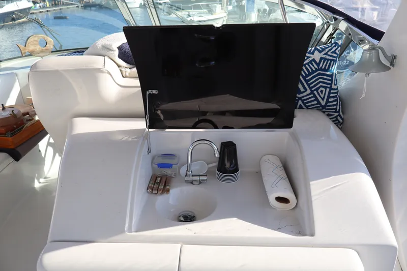 Slide: The Image of 2006 Bluewater Yachts 5200 sink area with faucet, paper towel, and accessories. - 17