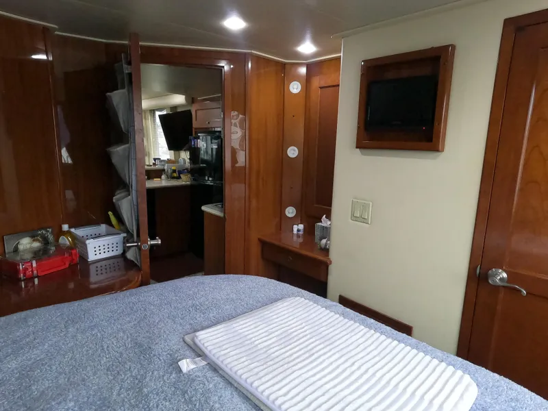 Slide: The Image of Interior of 2006 Bluewater Yachts 5200, featuring wood paneling and a cozy cabin space. - 20