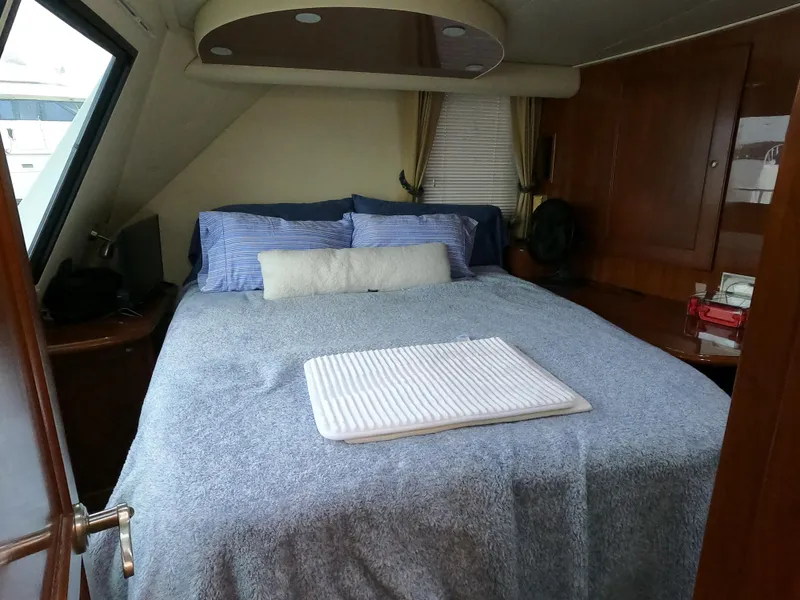 Slide: The Image of Luxurious bedroom interior of 2006 Bluewater Yachts 5200 with cozy bedding and elegant decor. - 21