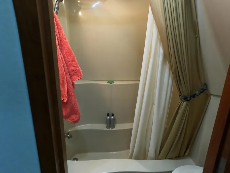 Slide: The Image of Bathroom with shower in 2006 Bluewater Yachts 5200, featuring curtain and towel. - 22