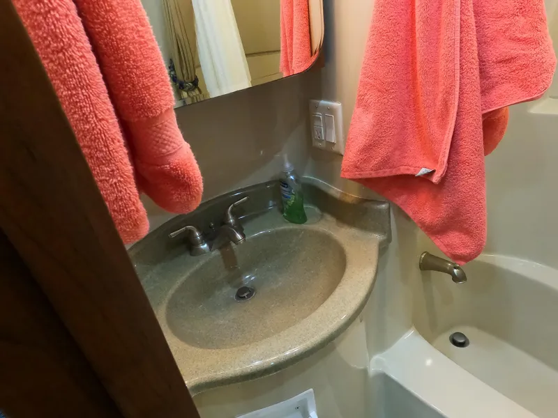 Slide: The Image of Bathroom sink and tub in 2006 Bluewater Yachts 5200, with pink towels. - 23
