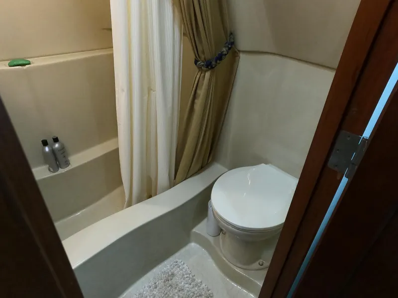 Slide: The Image of Bathroom interior of 2006 Bluewater Yachts 5200, featuring shower and toilet. - 24