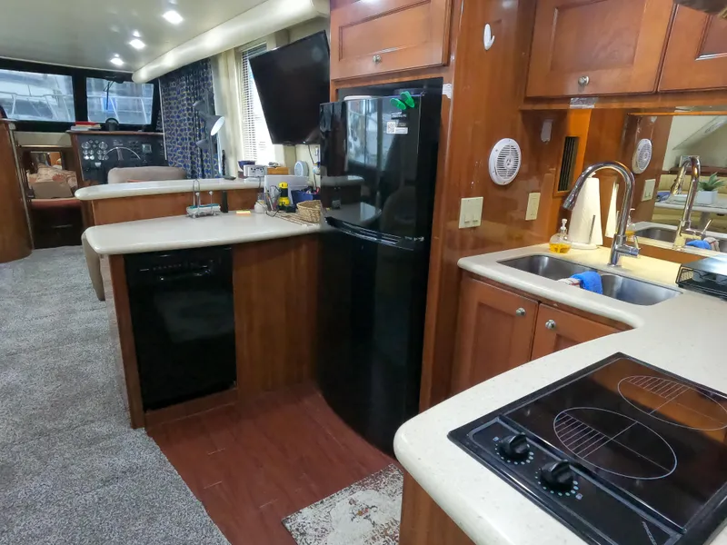 Slide: The Image of Interior of 2006 Bluewater Yachts 5200, featuring kitchen with modern appliances and cozy living space. - 26