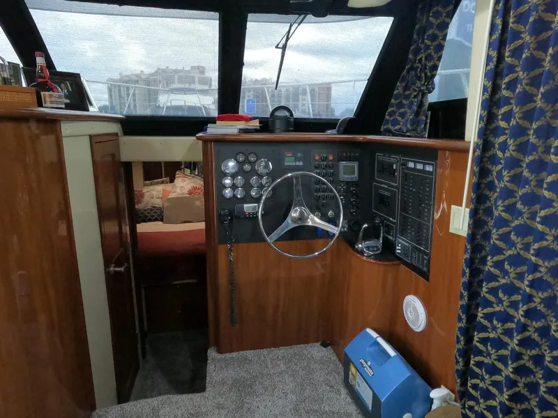 Slide: The Image of Interior helm of 2006 Bluewater Yachts 5200, featuring control panel and steering wheel. - 30