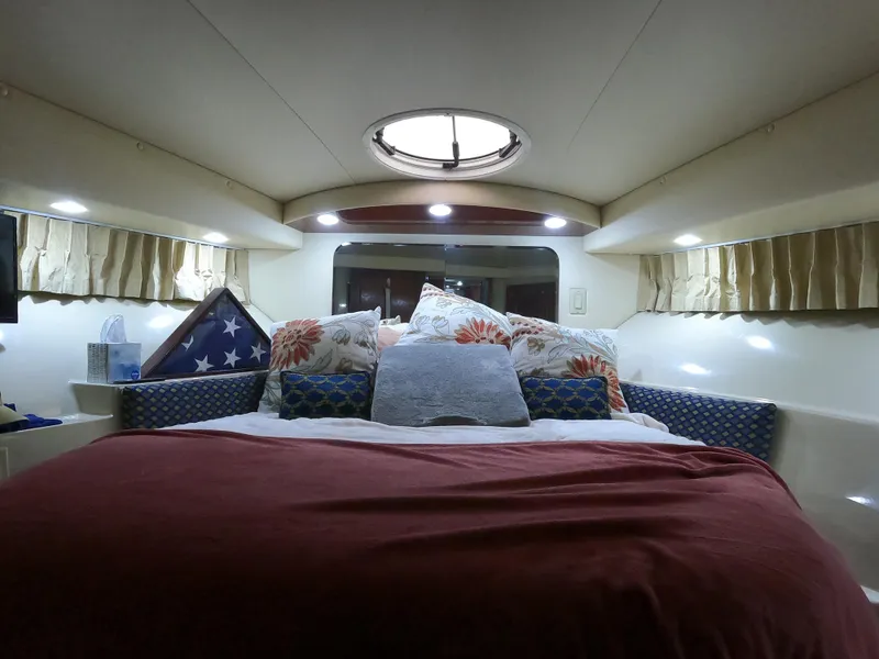 Slide: The Image of Cozy bedroom interior of 2006 Bluewater Yachts 5200 with plush bedding and soft lighting. - 31