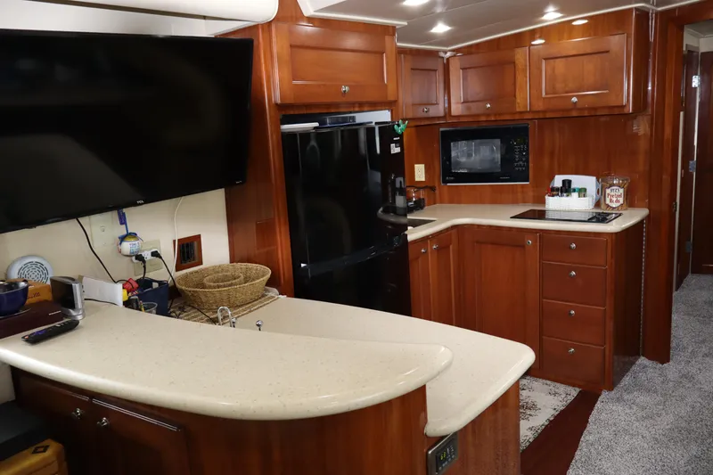 Slide: The Image of Luxurious interior of 2006 Bluewater Yachts 5200 with modern kitchen and entertainment area. - 37