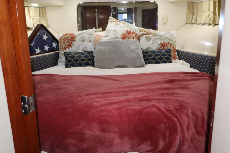 Slide: The Image of Cozy bedroom in 2006 Bluewater Yachts 5200 with plush pillows and red blanket. - 39