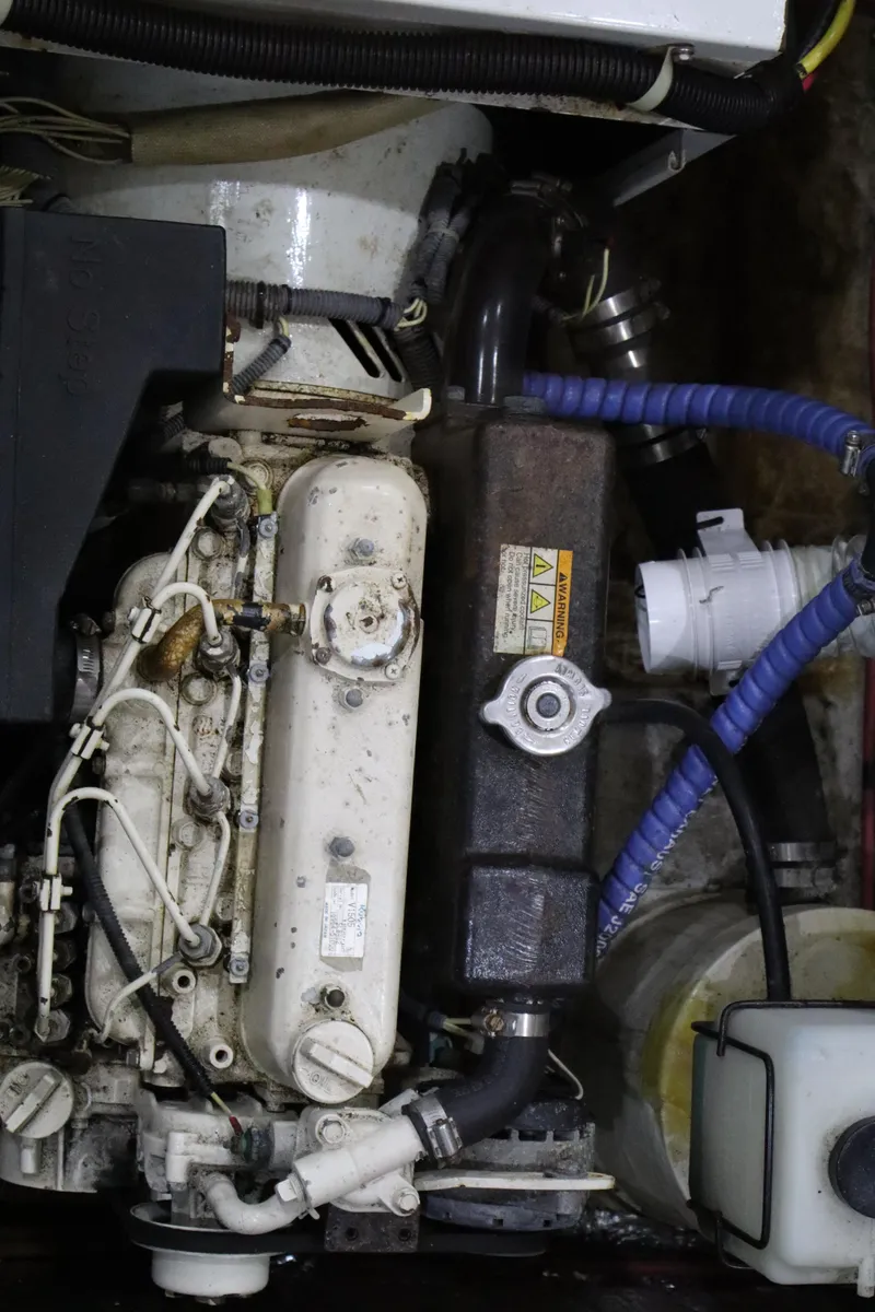 Slide: The Image of Engine compartment of a 2006 Bluewater Yachts 5200, showcasing mechanical components and hoses. - 40