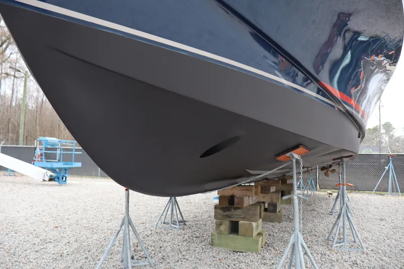 Slide: The Image of 2006 Bluewater Yachts 5200 hull on stands, gravel yard setting. - 46