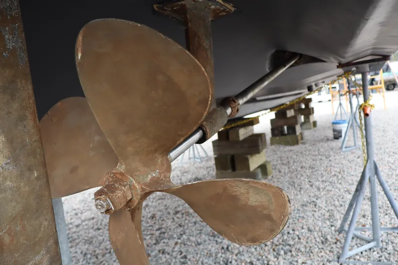 Slide: The Image of Propeller of 2006 Bluewater Yachts 5200 on dry dock, showcasing marine engineering. - 49