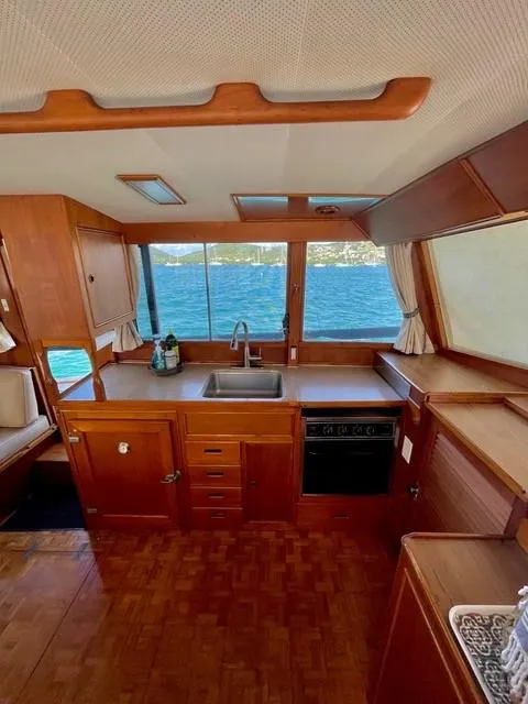 Slide: The Image of Interior of 1986 Grand Banks 42 Classic yacht with wooden cabinetry and ocean view. - 11