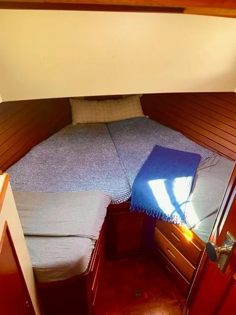 Slide: The Image of Cozy cabin interior of 1986 Grand Banks 42 Classic yacht with bed and wooden paneling. - 21