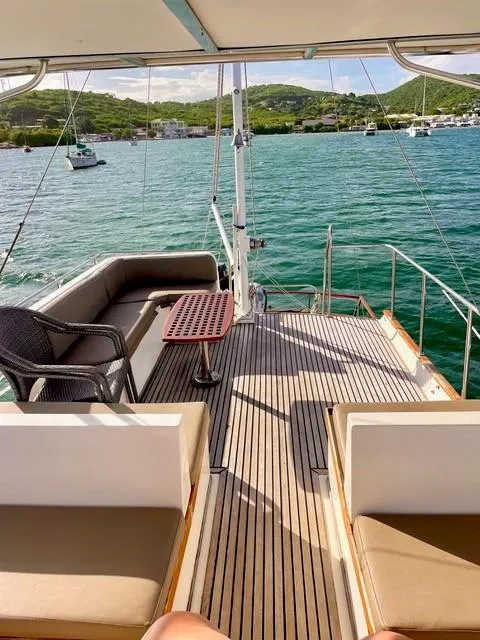 Slide: The Image of 1986 Grand Banks 42 Classic yacht deck with seating, overlooking serene waters and distant hills. - 33