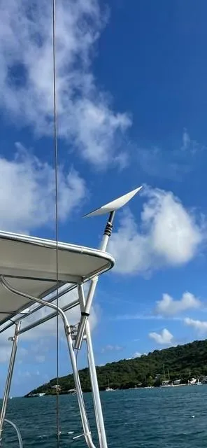 Slide: The Image of 1986 Grand Banks 42 Classic boat with antenna, blue sky, and coastal background. - 37