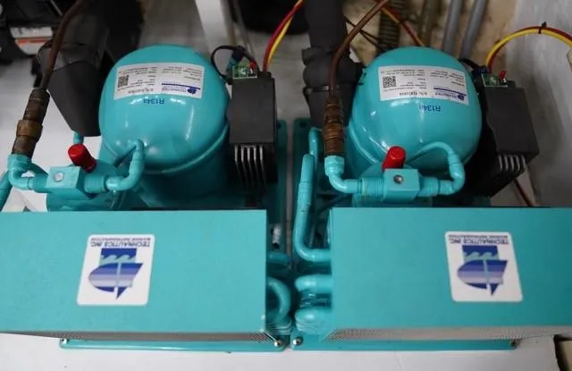 Slide: The Image of Twin compressors in a 1986 Grand Banks 42 Classic yacht engine room. - 38