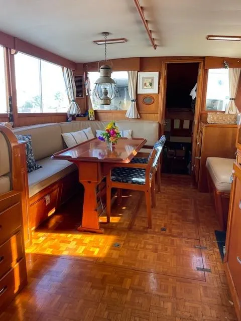 Slide: The Image of Interior of 1986 Grand Banks 42 Classic yacht with elegant wood furnishings and dining area. - 4