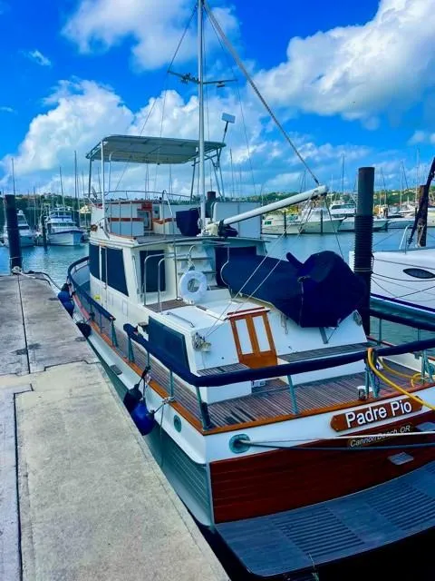 Slide: The Image of 1986 Grand Banks 42 Classic docked, blue sky. - 41