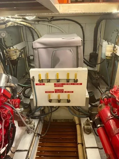 Slide: The Image of Engine room of a 1986 Grand Banks 42 Classic yacht, featuring mechanical components and wiring. - 44
