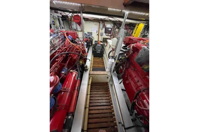 Slide: The Image of Engine room of a 1986 Grand Banks 42 Classic yacht, showcasing red machinery and equipment. - 47