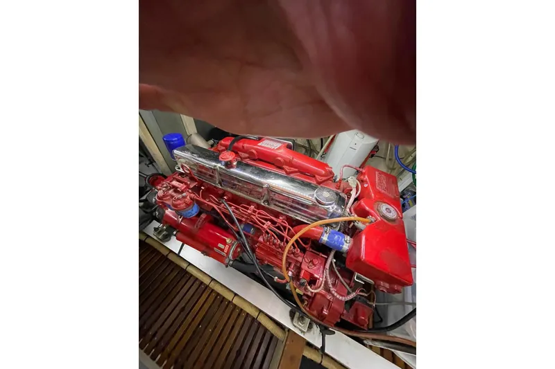 Slide: The Image of Engine of 1986 Grand Banks 42 Classic, featuring red components and intricate wiring. - 49