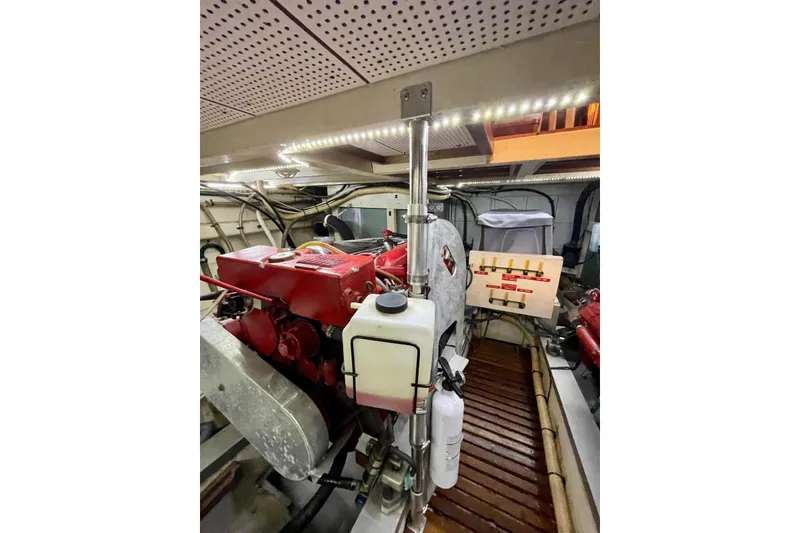 Slide: The Image of Engine room of 1986 Grand Banks 42 Classic yacht with red engine components. - 51