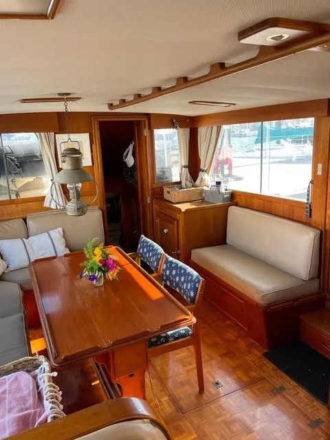 Slide: The Image of Interior of 1986 Grand Banks 42 Classic yacht with wooden furnishings and seating area. - 6