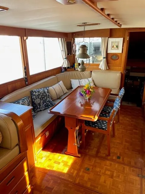 Slide: The Image of Interior of a 1986 Grand Banks 42 Classic yacht with elegant wood finish and cozy seating area. - 8