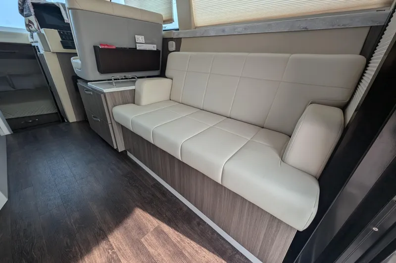 Slide: The Image of Interior of 2020 Regal 38 Grande Coupe with beige leather seating and wood flooring. - 14