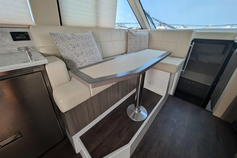 Slide: The Image of Interior of 2020 Regal 38 Grande Coupe with modern seating and table. - 15