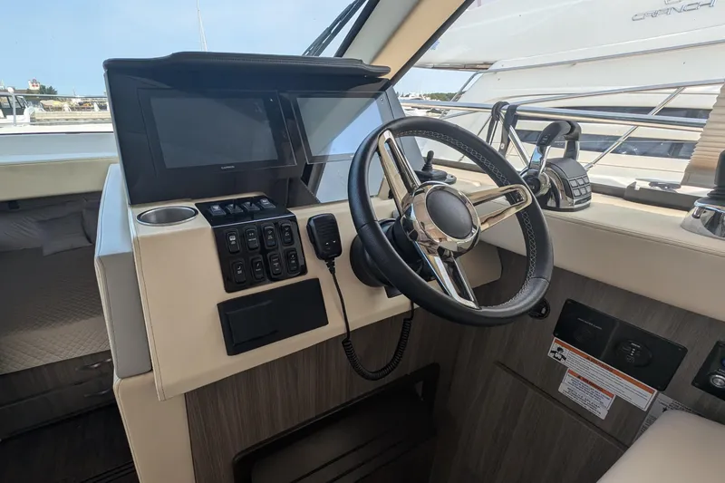 Slide: The Image of Helm of 2020 Regal 38 Grande Coupe with steering wheel and control panel. - 16