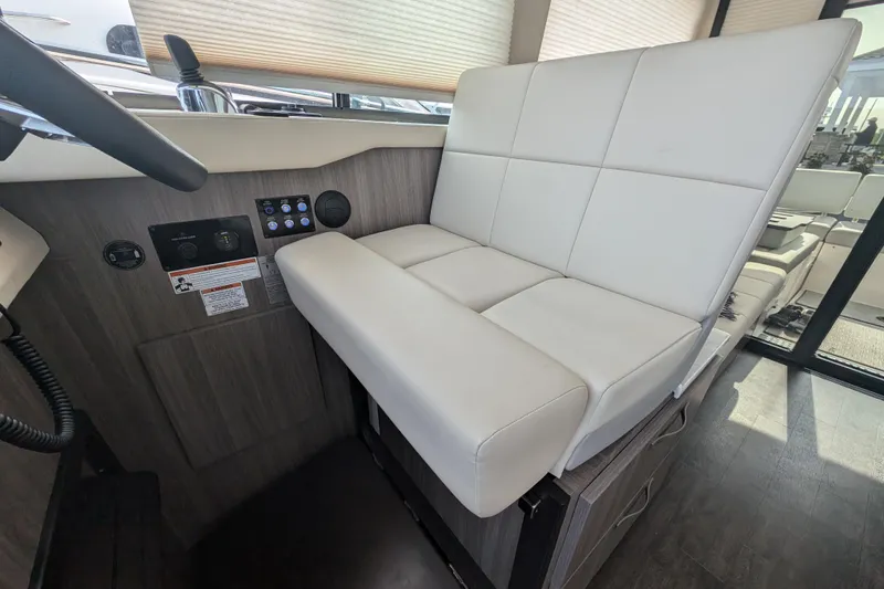 Slide: The Image of 2020 Regal 38 Grande Coupe interior helm seat with modern design and controls. - 17