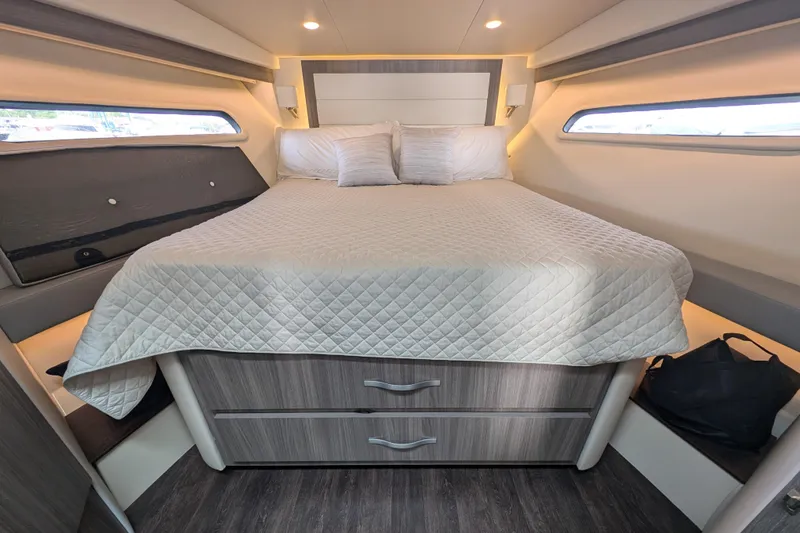 Slide: The Image of 2020 Regal 38 Grande Coupe cabin with bed, modern design, and ample storage. - 2
