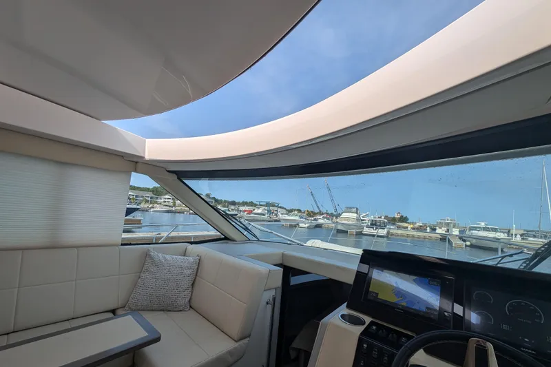 Slide: The Image of Interior view of 2020 Regal 38 Grande Coupe yacht with marina backdrop. - 21
