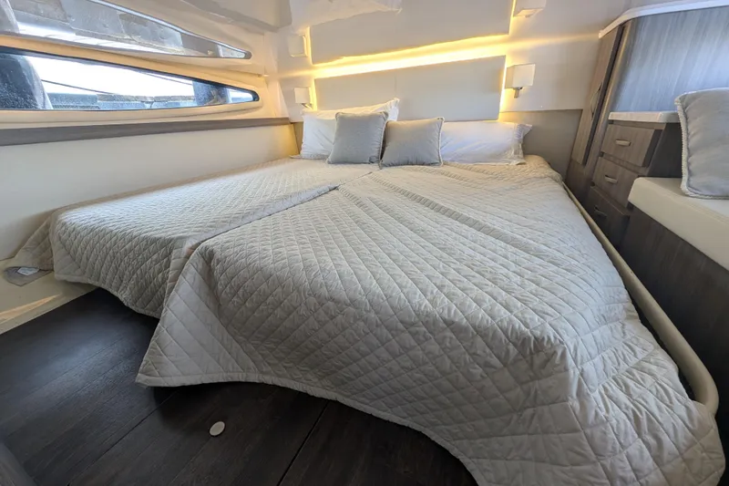 Slide: The Image of Luxurious bedroom interior of 2020 Regal 38 Grande Coupe yacht with modern bedding. - 3