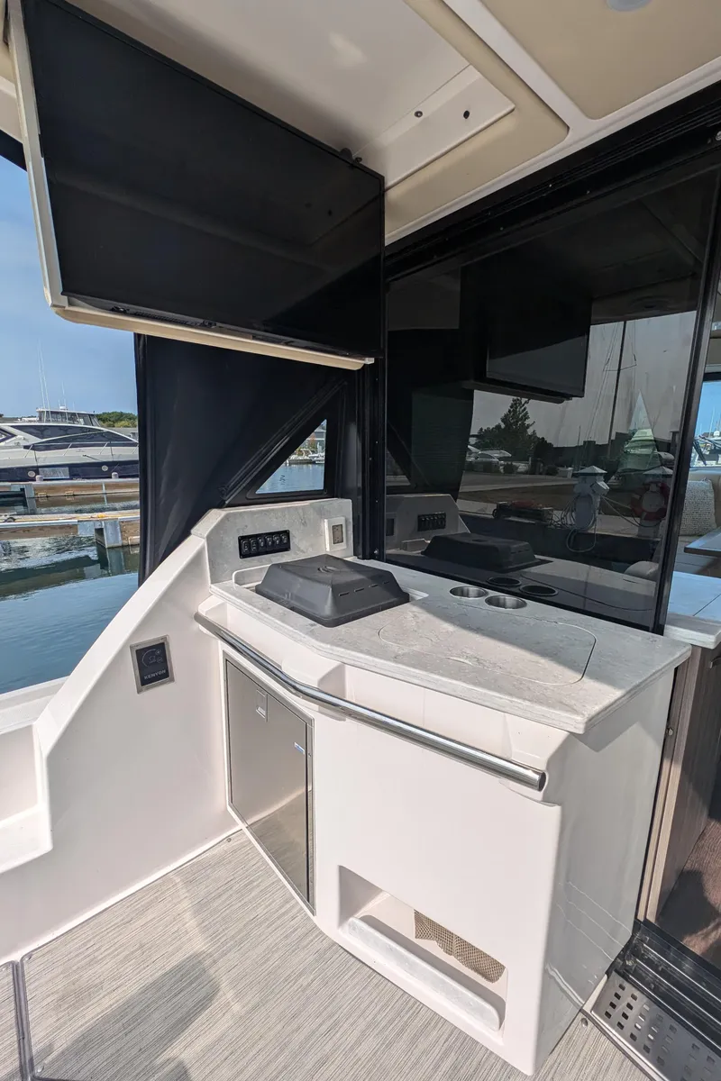 Slide: The Image of 2020 Regal 38 Grande Coupe yacht interior with modern kitchenette and sleek design. - 6