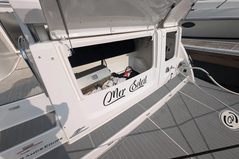 Slide: The Image of 2020 Regal 38 Grande Coupe yacht with open storage compartment on deck. - 9