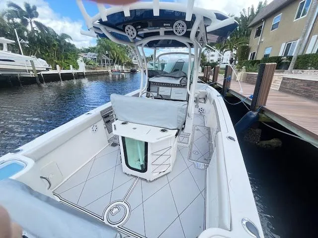 Slide: The Image of 2019 Wellcraft 262 F CC boat docked by a waterfront home. - 7