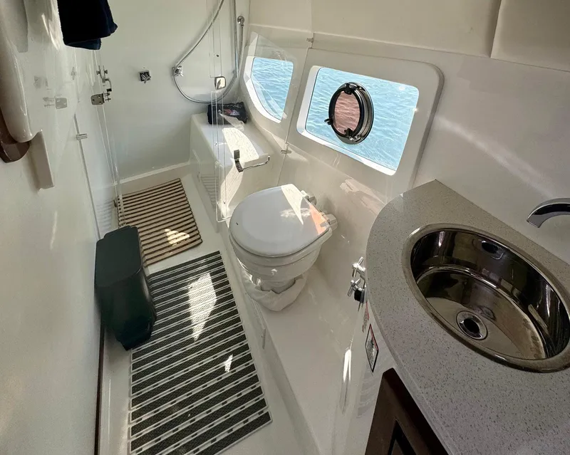 Slide: The Image of Modern bathroom in 2023 Schaefer 375 yacht with toilet, sink, and ocean view windows. - 12