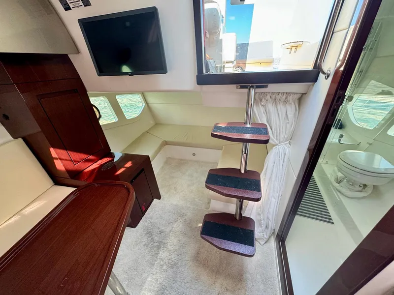 Slide: The Image of Interior of 2023 Schaefer 375 yacht with modern design, featuring stairs, seating, and a compact bathroom. - 14